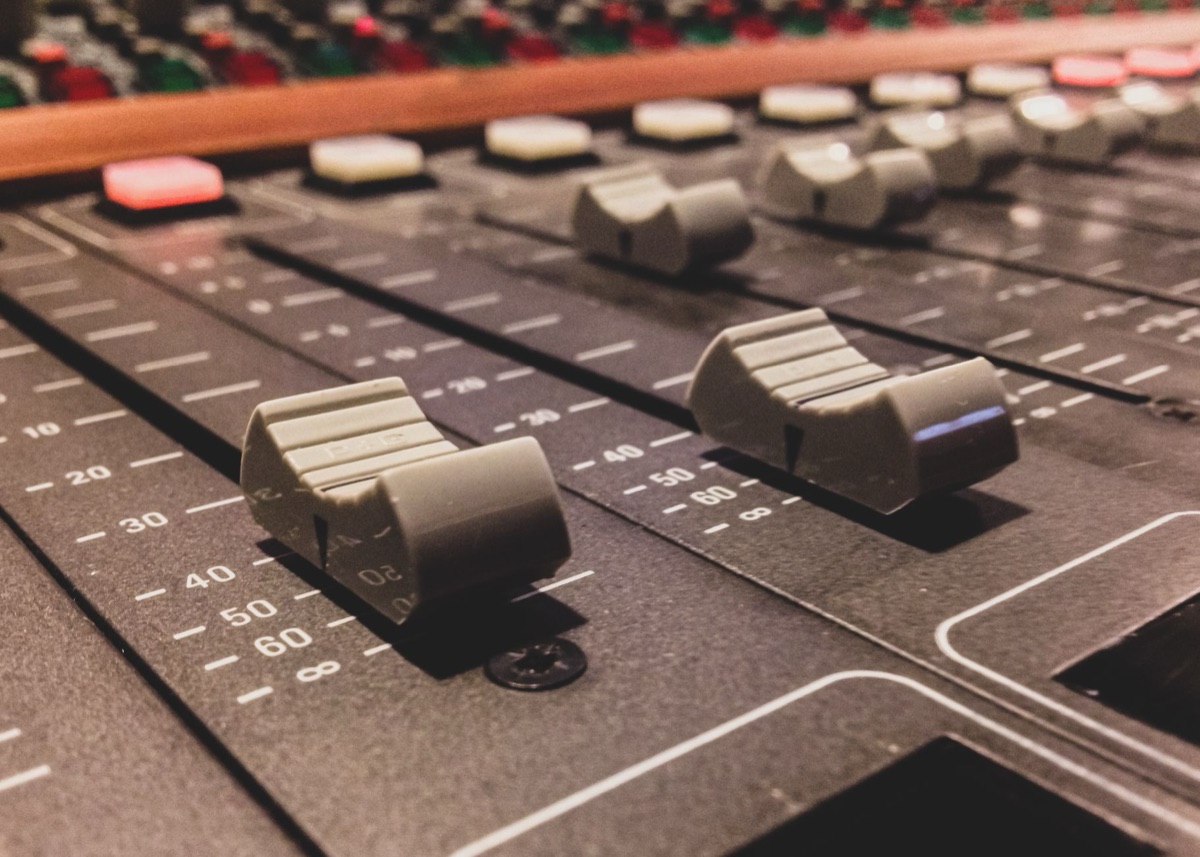 Close-up of analog sound mixing board controls
