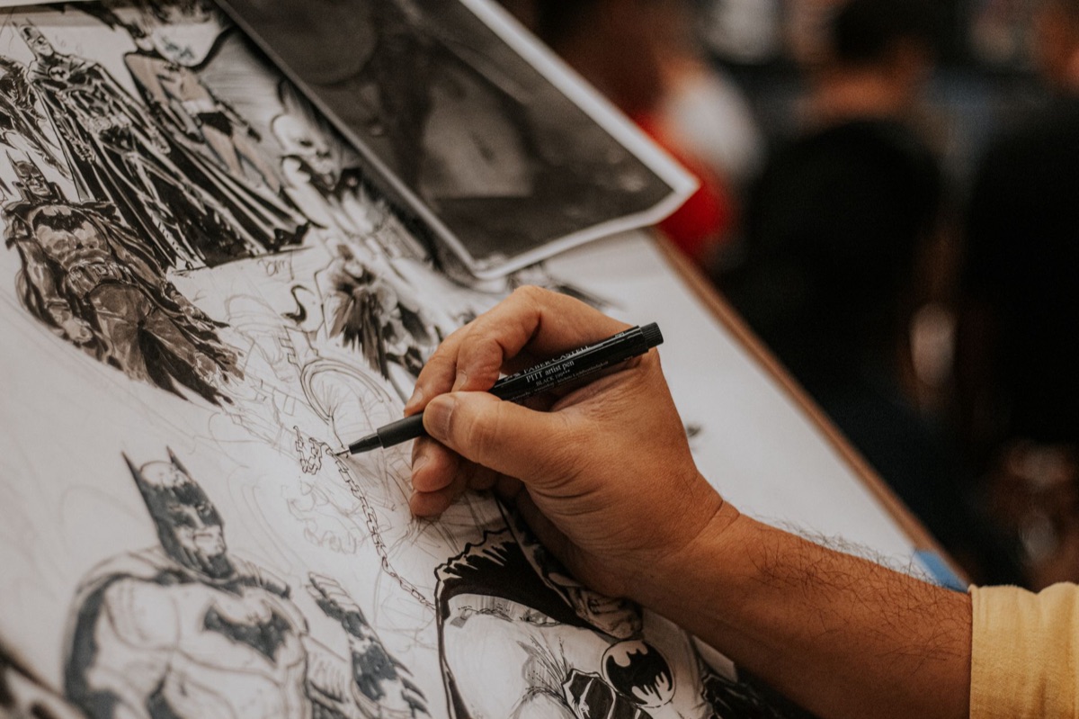 Detailed pencil sketches of anime characters on aged paper notebooks.